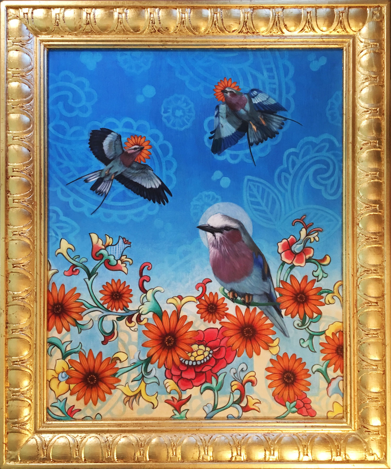 Painting of a three lilac breasted rollers (birds) on a blue paisley patterned background and multi-colored flowers in a gold-leafed frame.